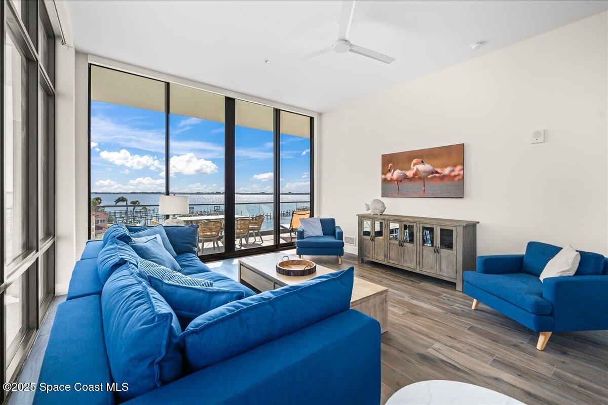 225 Strand Drive, Unit 401 Melbourne Beach, FL 32951 - Photo 14 of 51 a living room with furniture and a large window