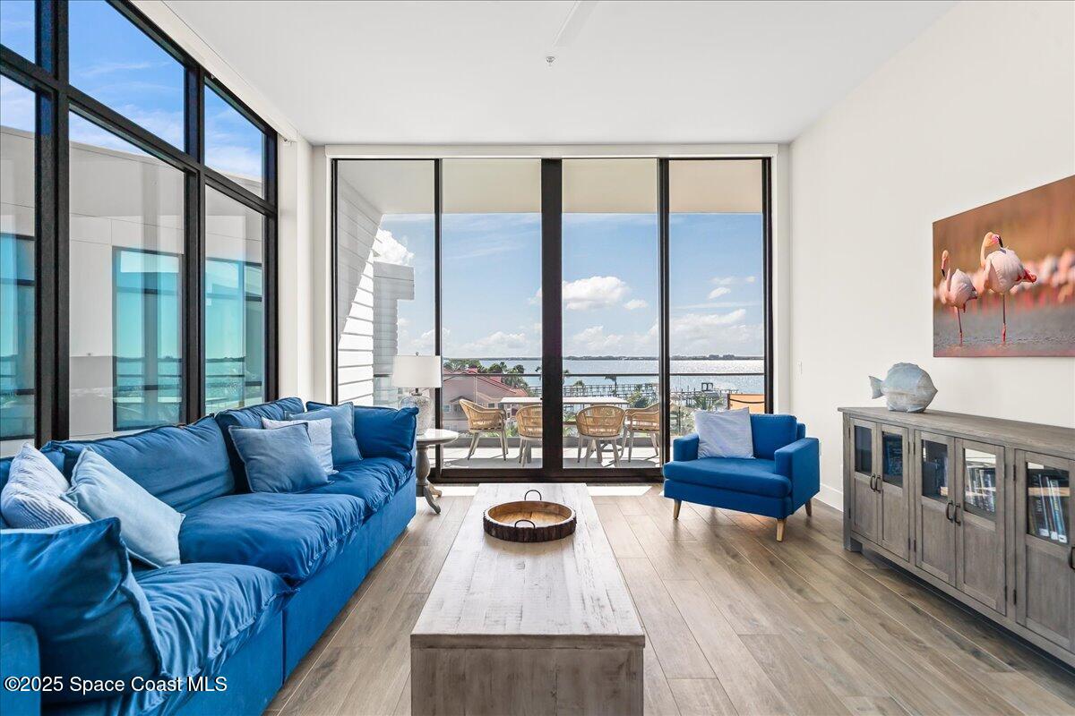 225 Strand Drive, Unit 401 Melbourne Beach, FL 32951 - Photo 16 of 51 a living room with furniture and a flat screen tv