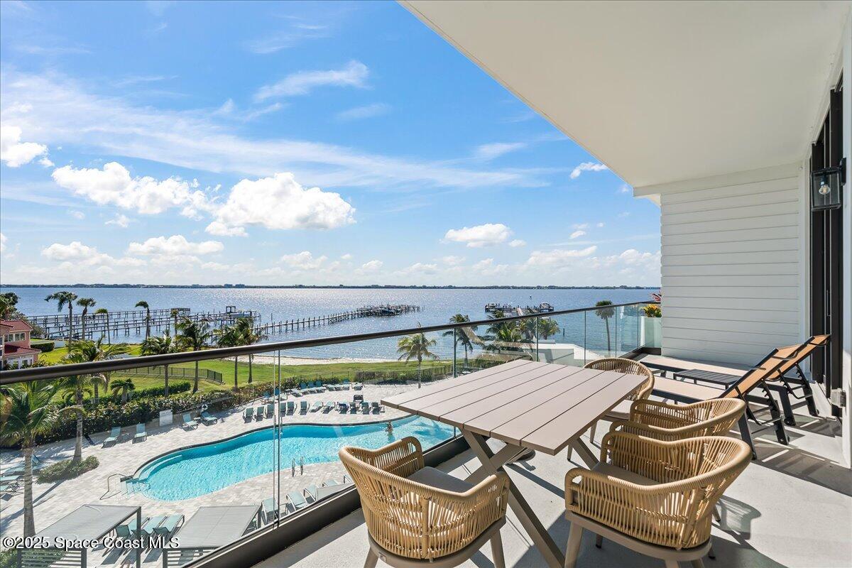225 Strand Drive, Unit 401 Melbourne Beach, FL 32951 - Photo 17 of 51 a terrace with outdoor seating and city view
