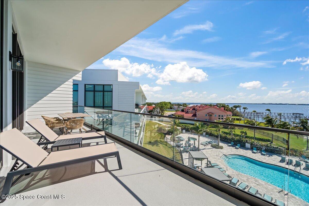 225 Strand Drive, Unit 401 Melbourne Beach, FL 32951 - Photo 18 of 51 a view of a balcony with chairs and a table