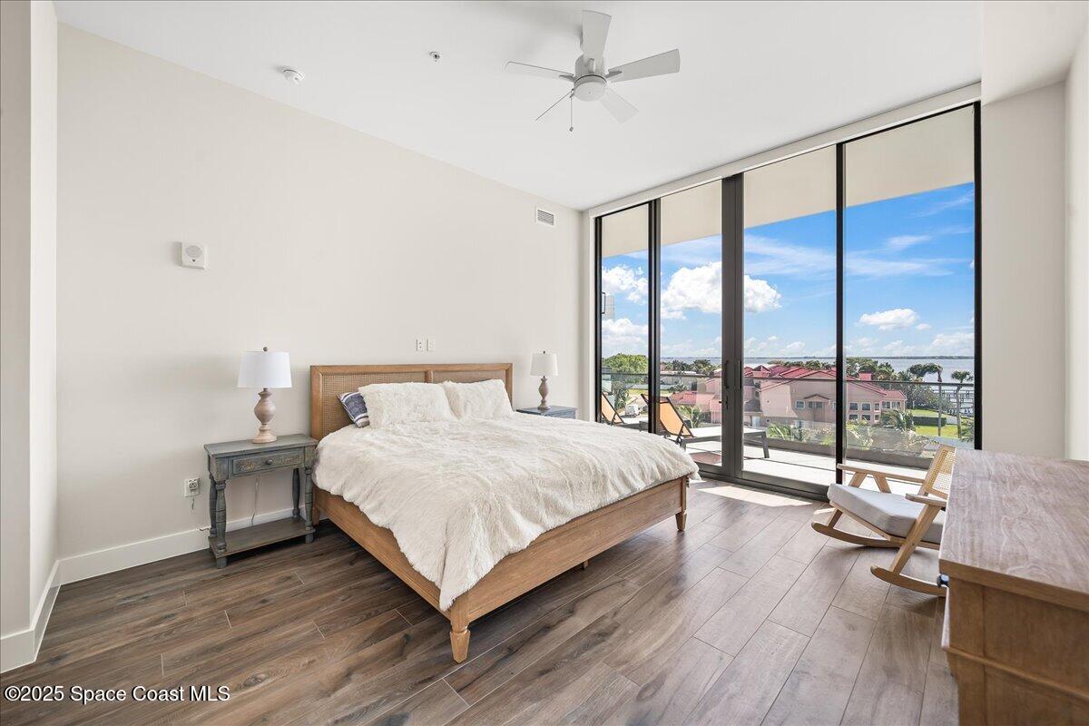 225 Strand Drive, Unit 401 Melbourne Beach, FL 32951 - Photo 20 of 51 a large bedroom with a bed and a large window