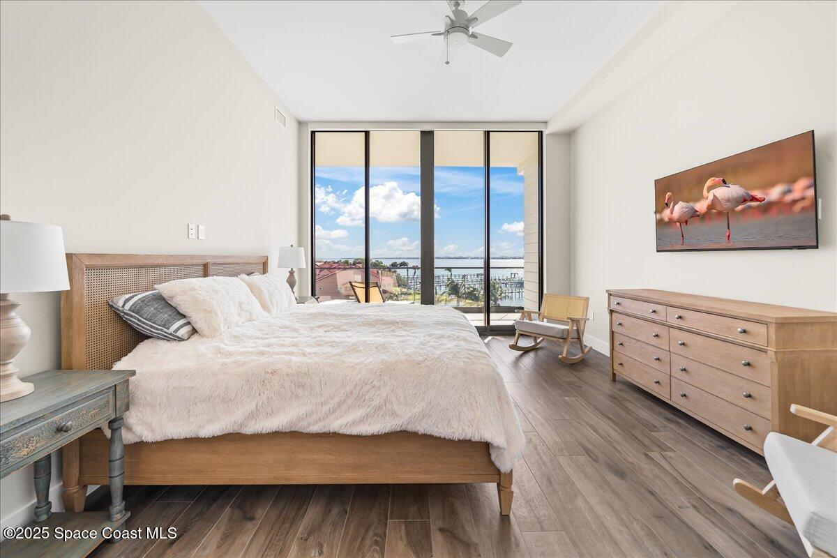 225 Strand Drive, Unit 401 Melbourne Beach, FL 32951 - Photo 21 of 51 a bedroom with a bed and a flat screen tv