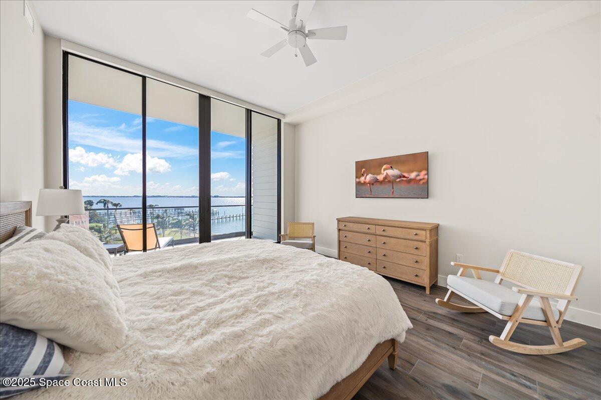 225 Strand Drive, Unit 401 Melbourne Beach, FL 32951 - Photo 22 of 51 a bedroom with a bed and wooden floor