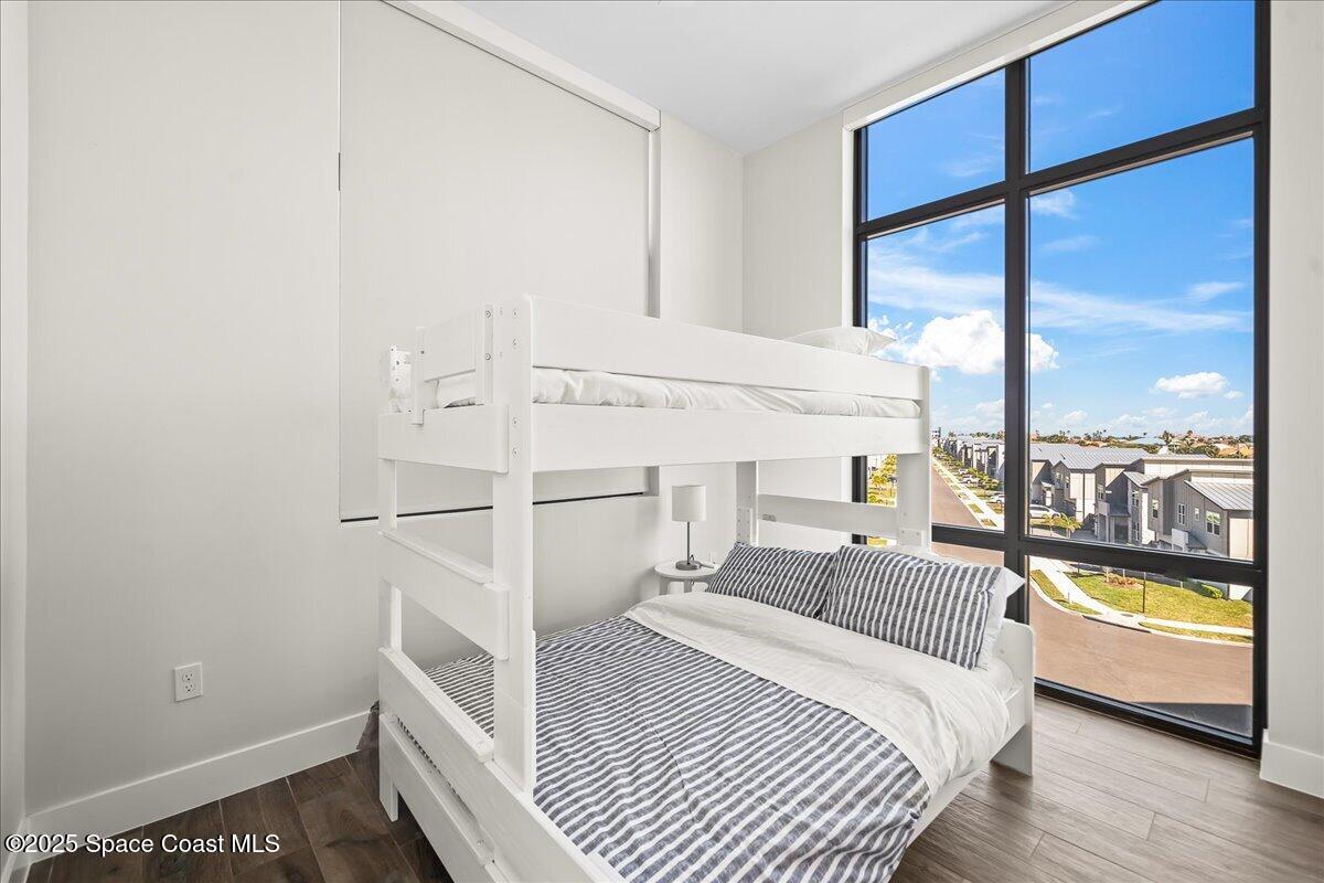 225 Strand Drive, Unit 401 Melbourne Beach, FL 32951 - Photo 26 of 51 a bedroom with a bed and a large window