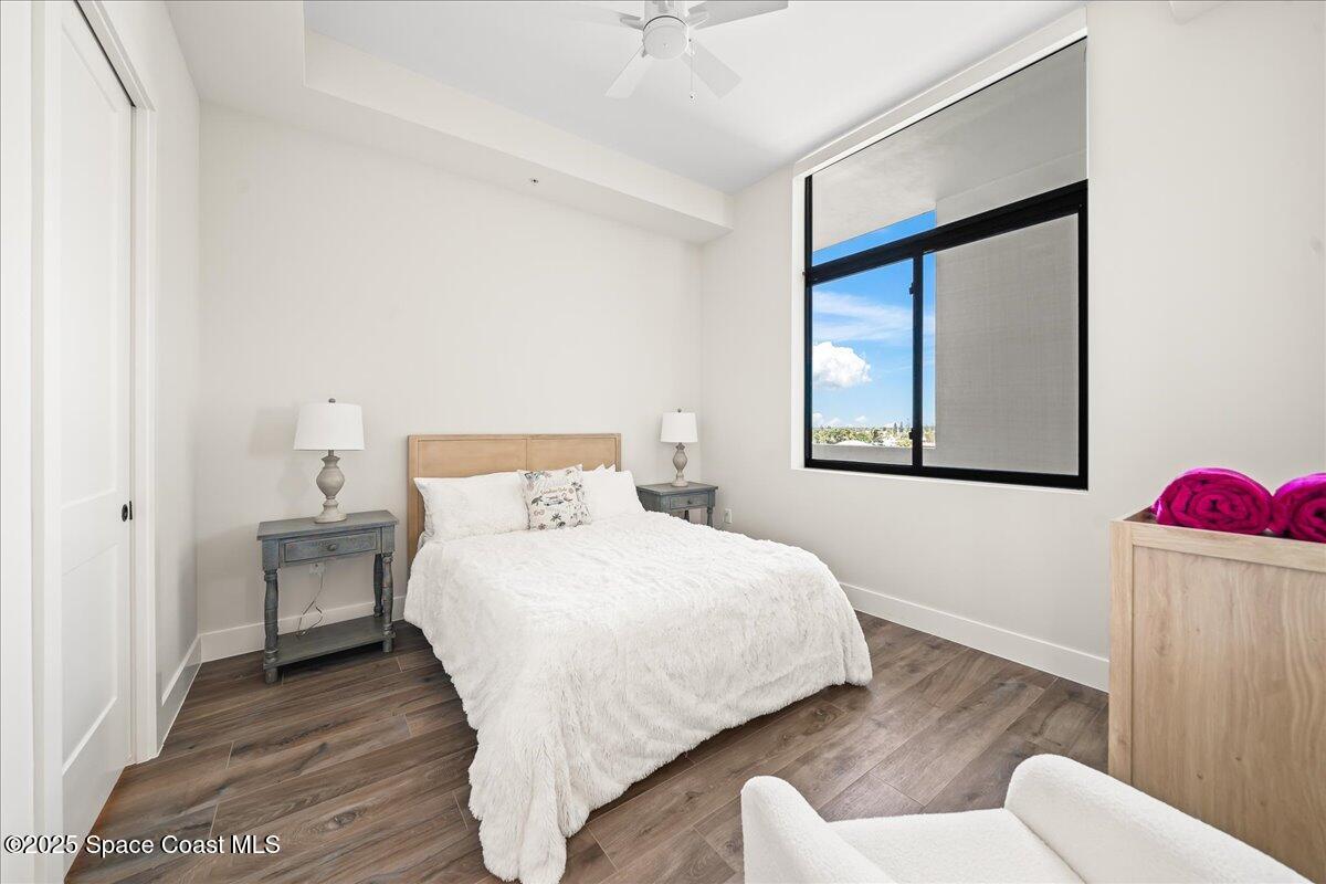 225 Strand Drive, Unit 401 Melbourne Beach, FL 32951 - Photo 30 of 51 a bedroom with a bed and a potted plant