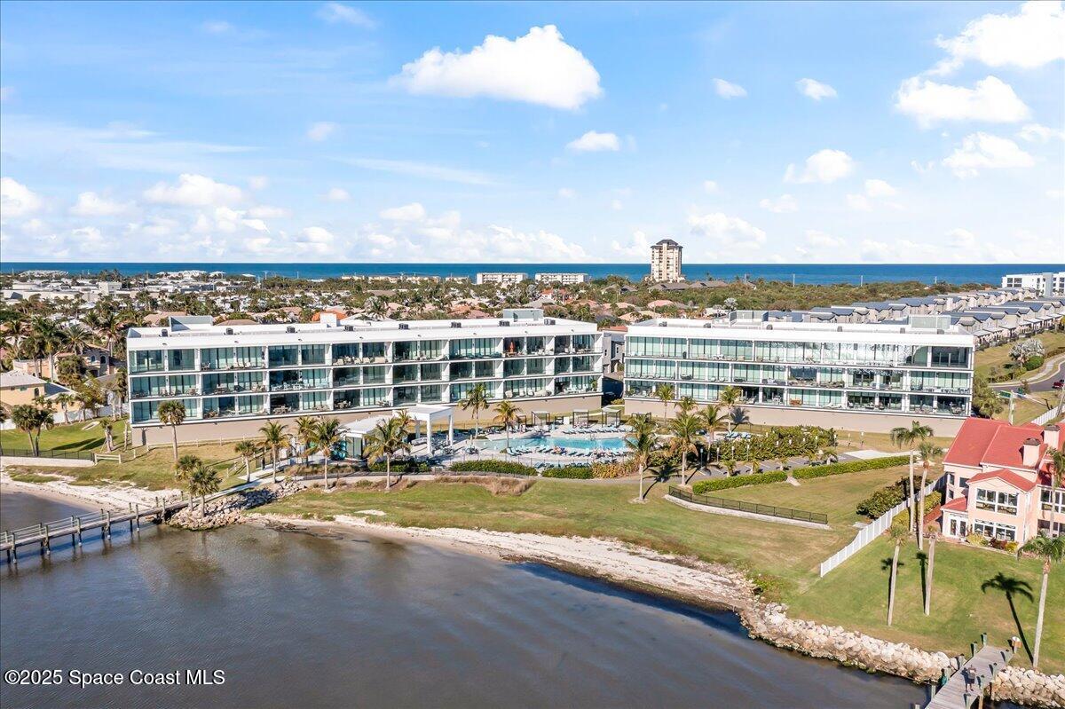 225 Strand Drive, Unit 401 Melbourne Beach, FL 32951 - Photo 36 of 51 a view of a swimming pool with an ocean view