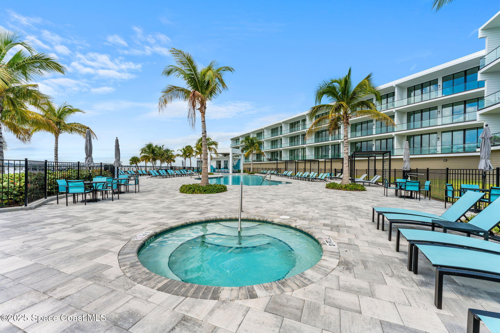 225 Strand Drive, Unit 401 Melbourne Beach, FL 32951 - Photo 43 of 51 a swimming pool with outdoor seating