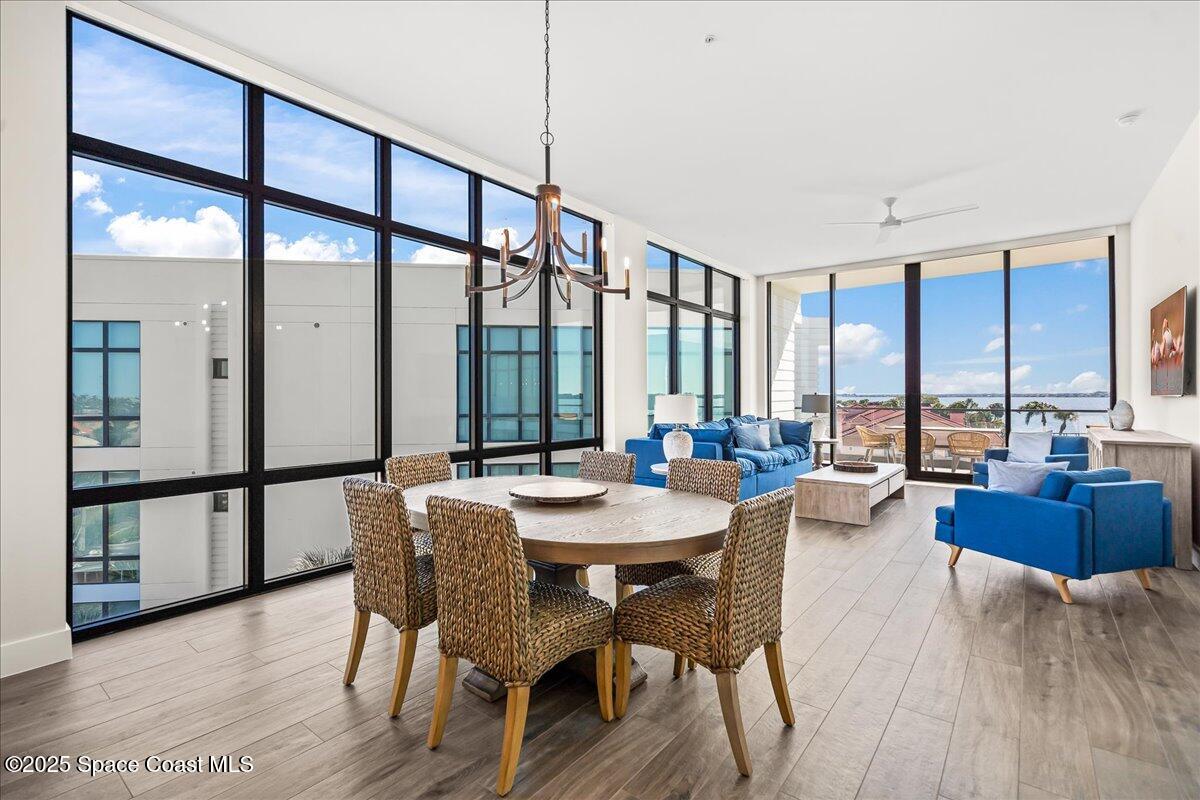 225 Strand Drive, Unit 401 Melbourne Beach, FL 32951 - Photo 9 of 51 a view of a dining room with furniture window and wooden floor