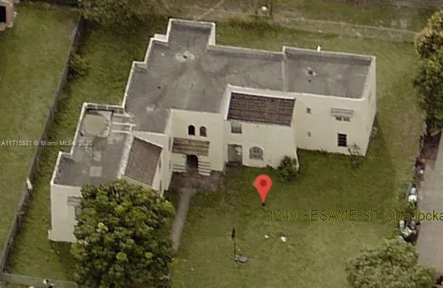 an aerial view of a house with a swimming pool