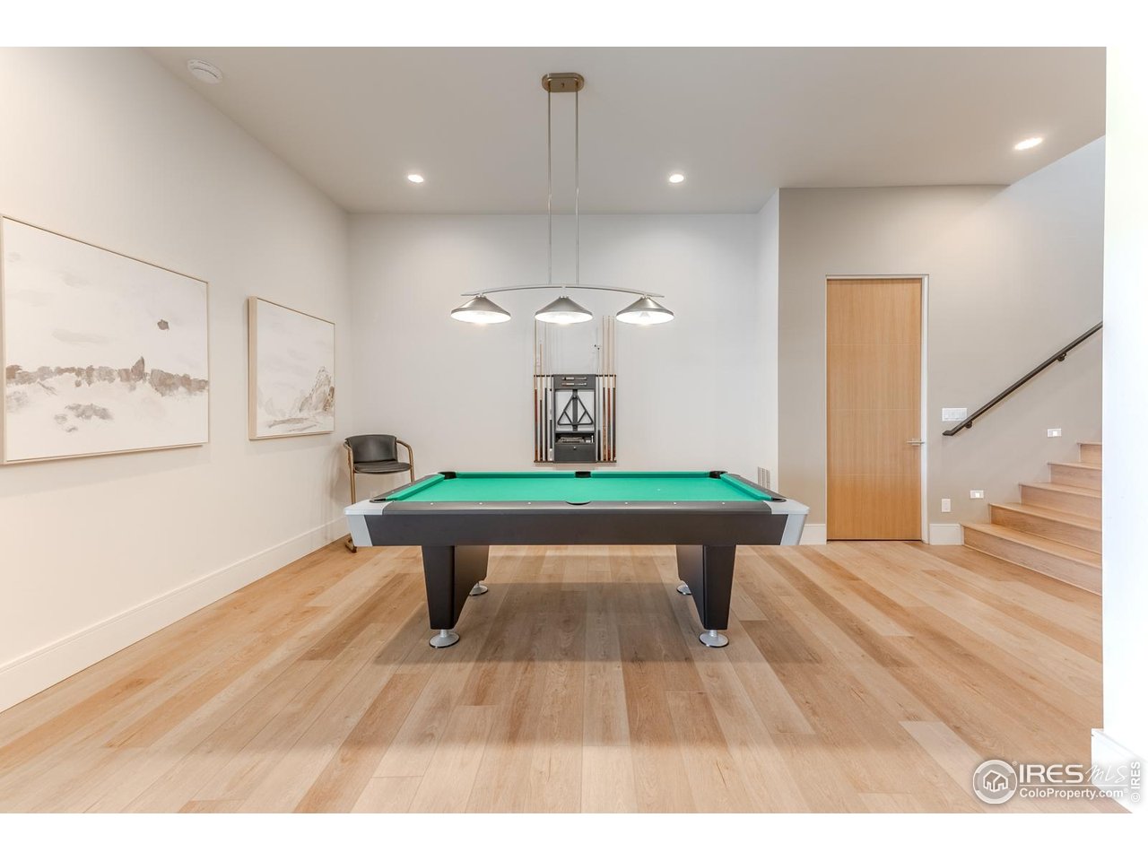 7572 Raphael Lane Littleton, CO 80125 - Photo 33 of 50 The billiards zone offers an inviting space for casual play and conversation, designed to flow effortlessly into the adjoining entertainment areas.