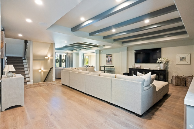 3 Carriagewood Cove, Unit 1088 Sandy, UT 84092 - Photo 51 of 79 Spacious entertainment area featuring light wood-finish flooring, recessed lighting, and exposed ceiling beams