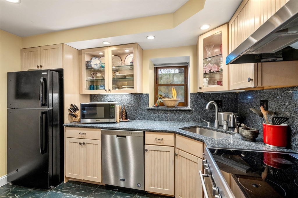 101 Summit Avenue, Unit E Brookline, MA 02446 - Photo 12 of 22 a kitchen with stainless steel appliances a sink stove and refrigerator