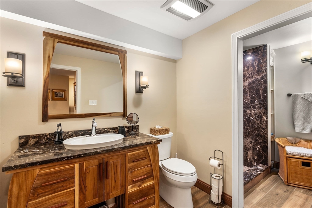 101 Summit Avenue, Unit E Brookline, MA 02446 - Photo 13 of 22 a bathroom with a granite countertop sink toilet and mirror