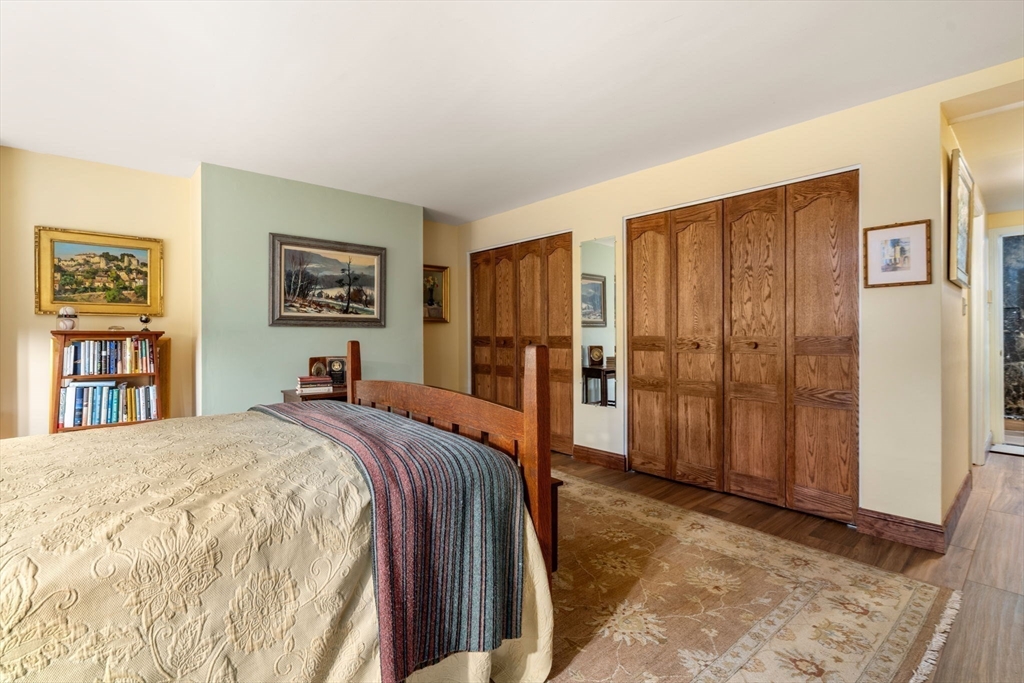 101 Summit Avenue, Unit E Brookline, MA 02446 - Photo 16 of 22 a spacious bedroom with a bed and a cabinets