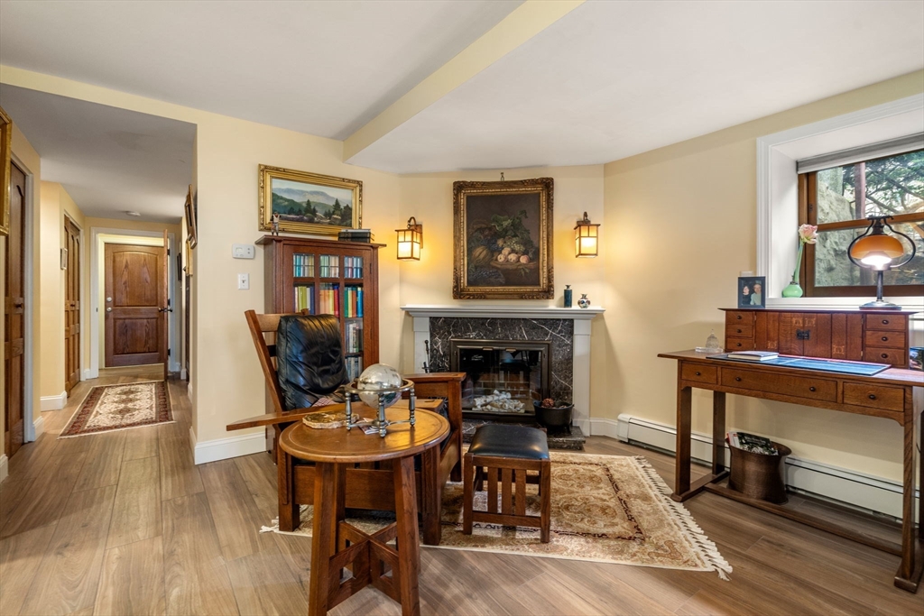 101 Summit Avenue, Unit E Brookline, MA 02446 - Photo 9 of 22 a living room with furniture and a fireplace