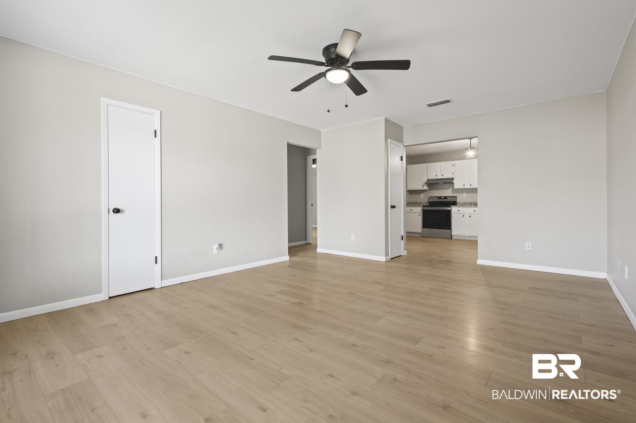 309 West Roosevelt Avenue Foley, AL 36535 - Photo 14 of 60 Unfurnished living room featuring light wood-type flooring and ceiling fan