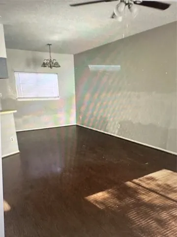 a view of a room with wooden floor