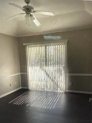 a view of a room with wooden floor and windows