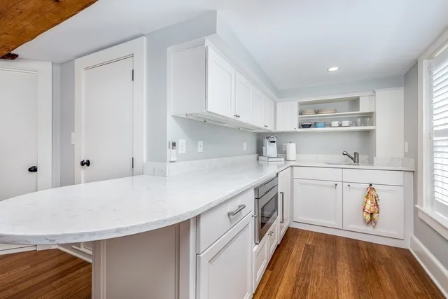 a kitchen with a sink appliances and cabinets