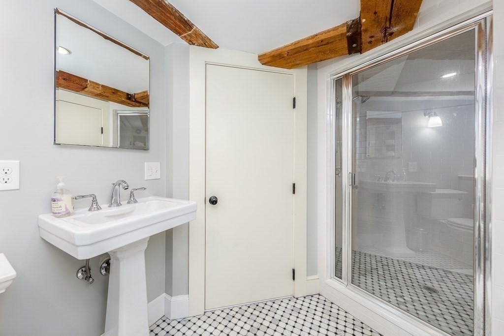 51 Washington Street Marblehead, MA 01945 - Photo 5 of 6 a bathroom with a sink and a mirror
