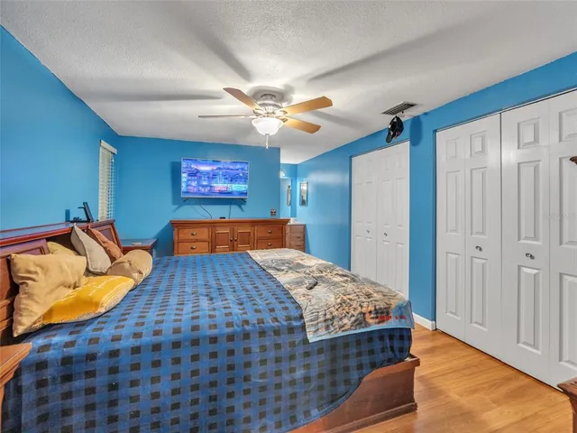 a bedroom with a bed and a chandelier