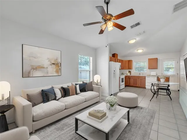 a living room with furniture a rug and a chandelier