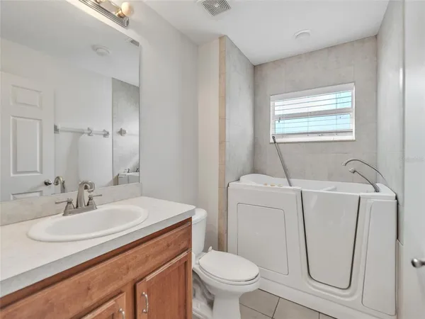 a bathroom with a sink toilet and a mirror