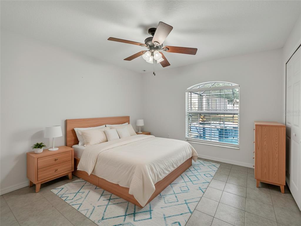 3509 King George Lane Seffner, FL 33584 - Photo 28 of 39 a bedroom with a bed and a chandelier