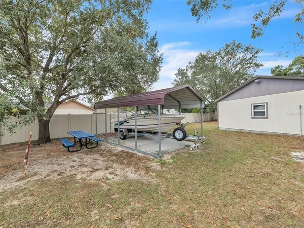 a view of a house with a bench and a tree