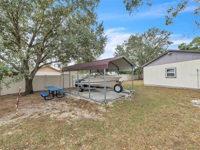 a view of a house with a bench and a tree