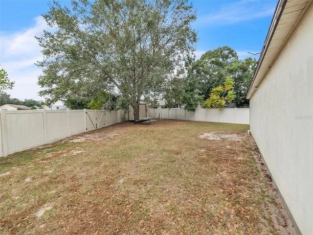 a view of a yard with a tree