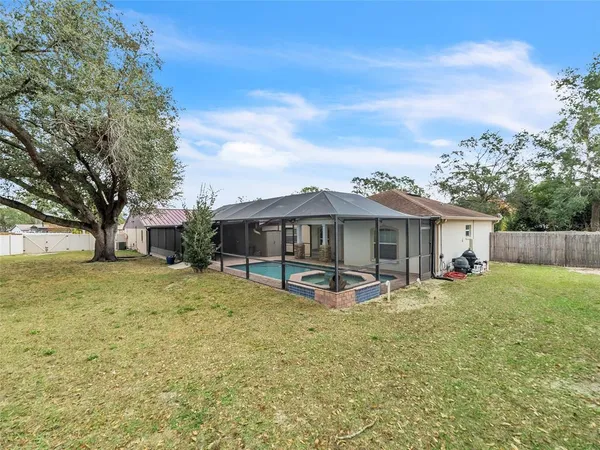 a view of a house with a yard and sitting area