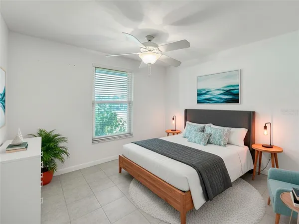 a bedroom with a bed and a potted plant