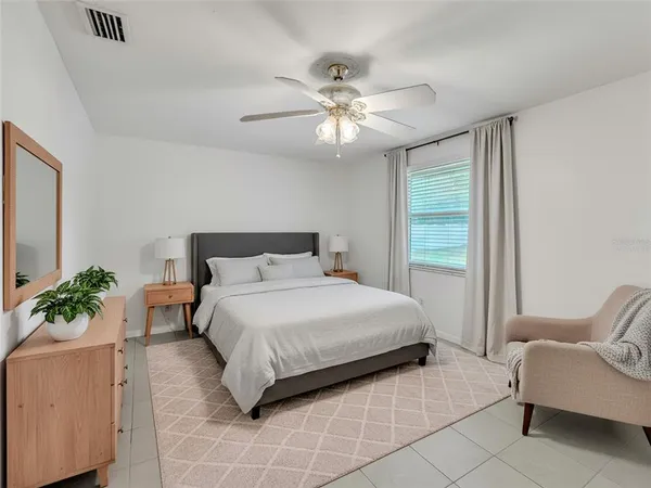 a bedroom with a bed and ceiling fan