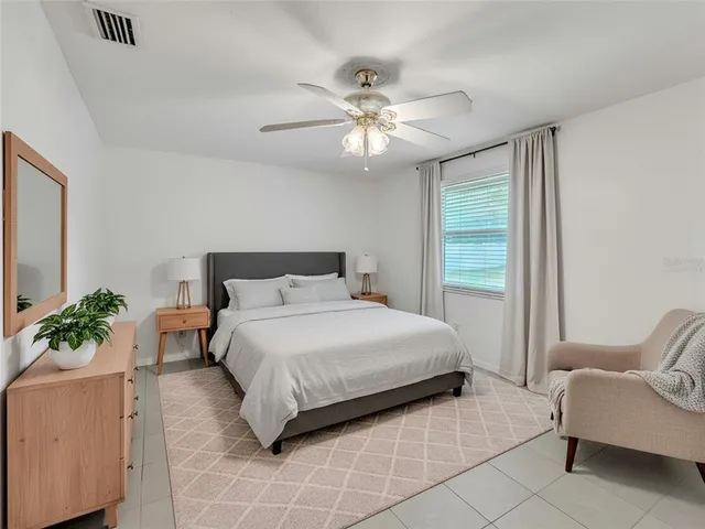 a bedroom with a bed and ceiling fan