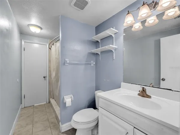 a bathroom with a sink a toilet a mirror and vanity