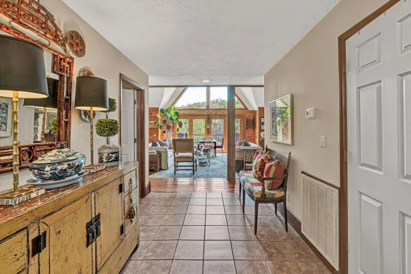 a dining room with stainless steel appliances granite countertop furniture wooden floor and a kitchen view