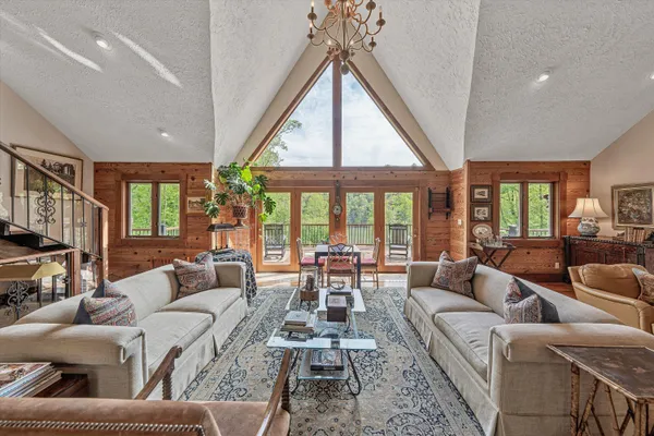 a large white kitchen with stainless steel appliances granite countertop a stove and cabinets