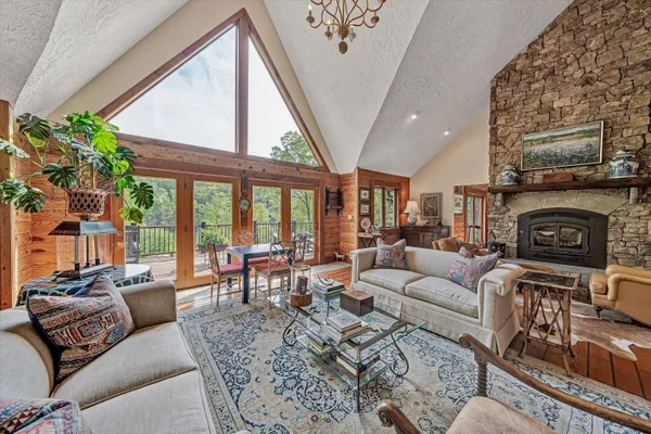 a very nice looking living room with a large window and wooden floors