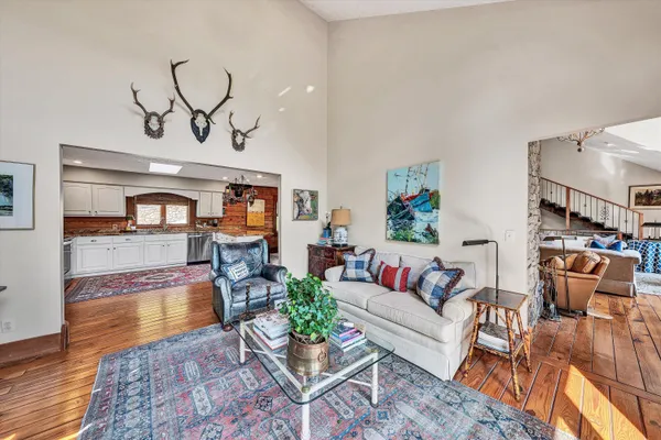 a view of a patio with table and chairs potted plants with wooden floor and floor to ceiling window