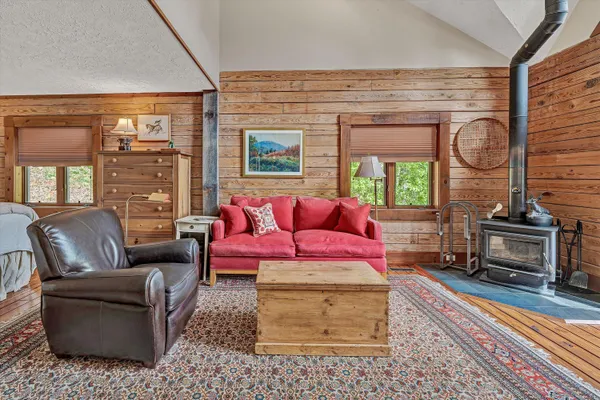 a view of a balcony with wooden floor and outdoor seating