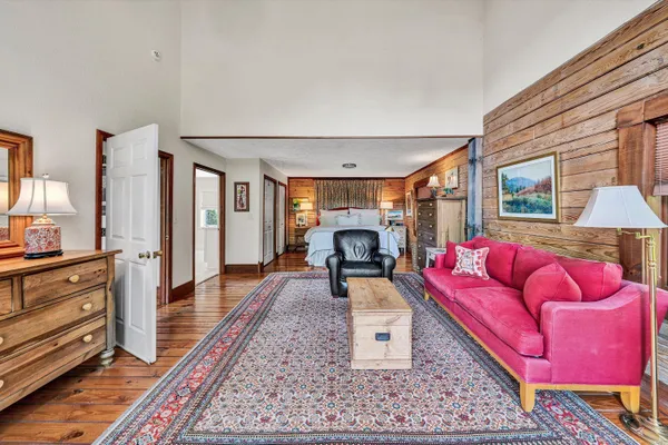 a view of staircase with wooden floor and a rug