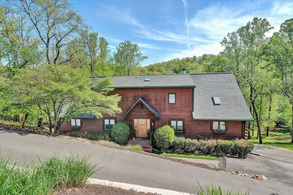 a view of a house with a yard and sitting area