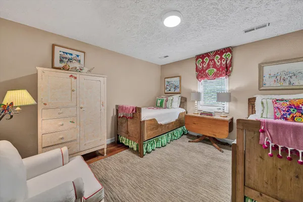 a view of a yard with plants and trees