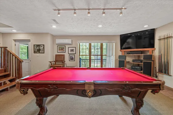 an aerial view of a house with a yard and lake view