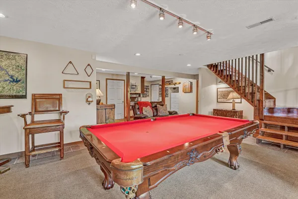 an aerial view of a house with a yard and lake view