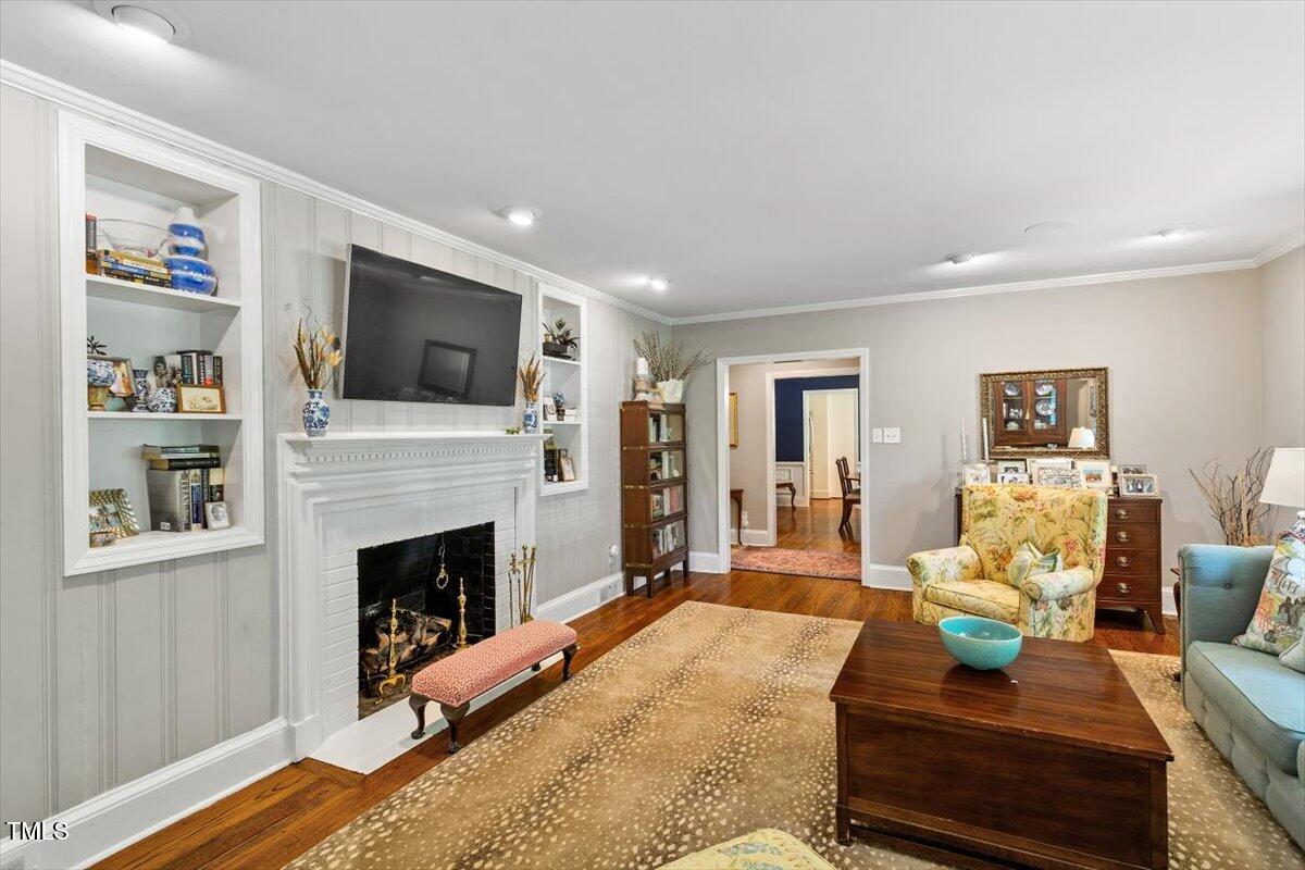 1417 Hathaway Road Raleigh, NC 27608 - Photo 8 of 34 a living room with furniture a flat screen tv and a fireplace