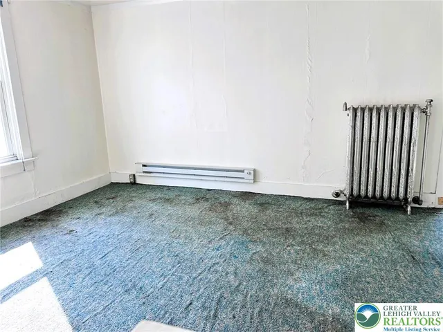 an empty room with wooden floor