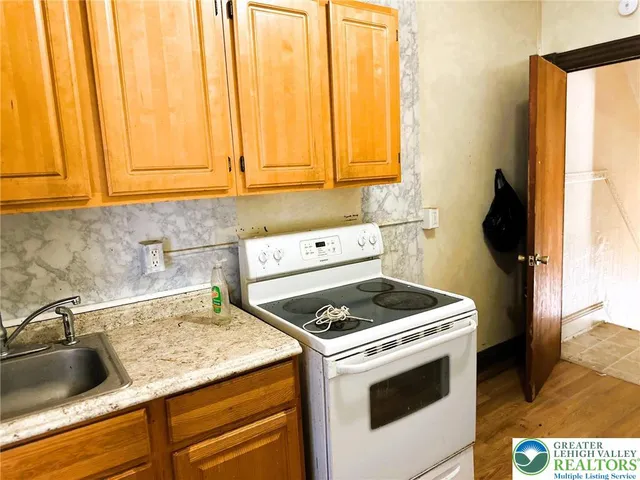 a kitchen with a stove and a sink