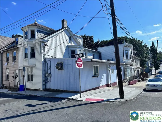 a view of a street with cars parked
